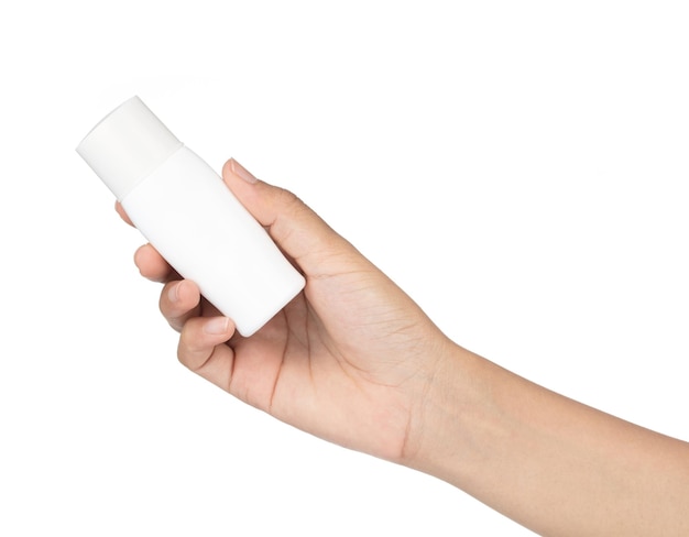 Hand holding sunscreen bottle isolated on white background.