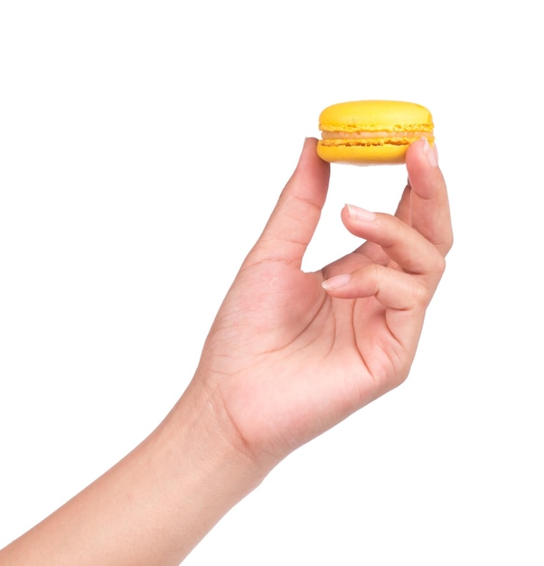 hand holding Sweet and colourful french macaroons or macaron isolated on white background