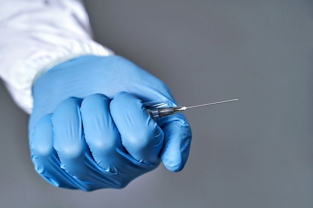 Hand holding syringe isolated on white background