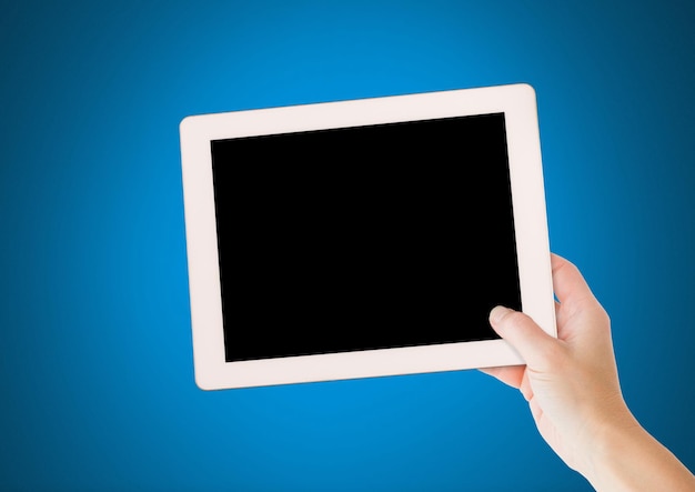 Hand holding tablet with blue background