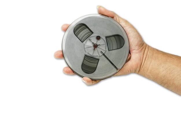 hand holding Tape of reel tape recorder on white background