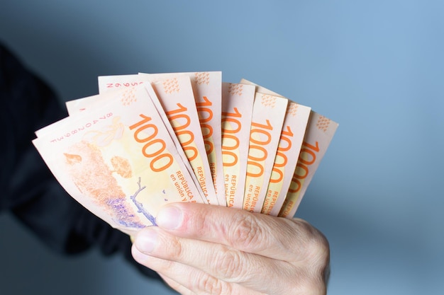 Hand holding thousand banknotes on white background