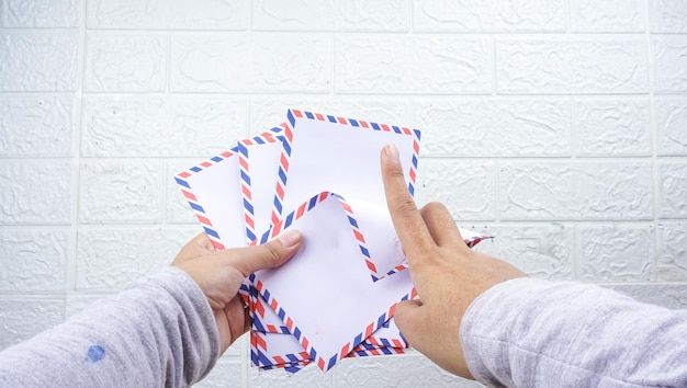 Photo hand holding the thr envelope contains indonesian money thr is a holiday allowance on eid alfitr