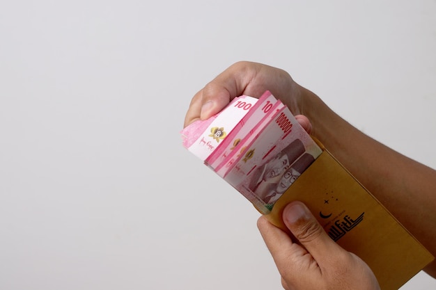 Hand Holding THR Money Indonesian Holiday Bonus