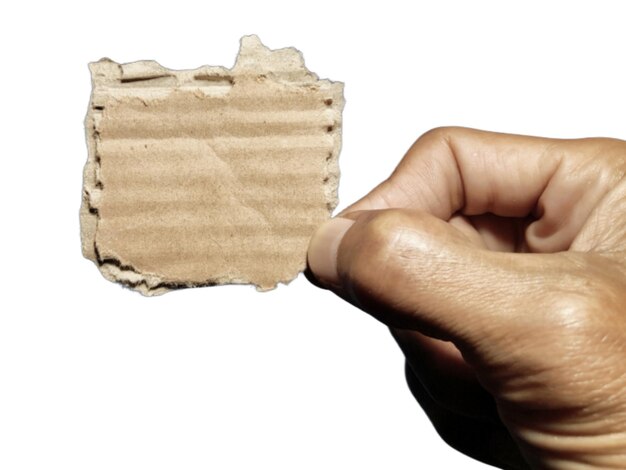 Hand holding torn cardboard paper of brown textured