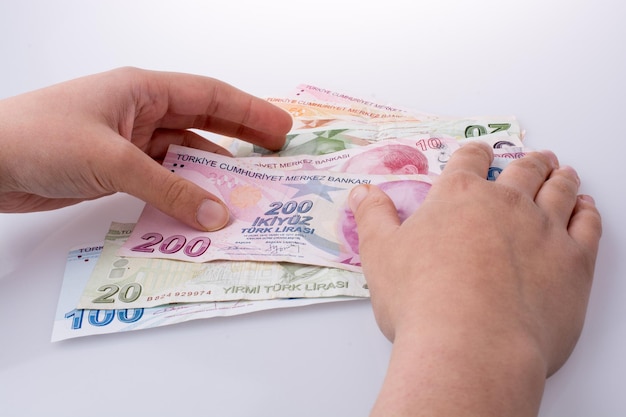 Hand holding Turksh Lira banknotes in hand