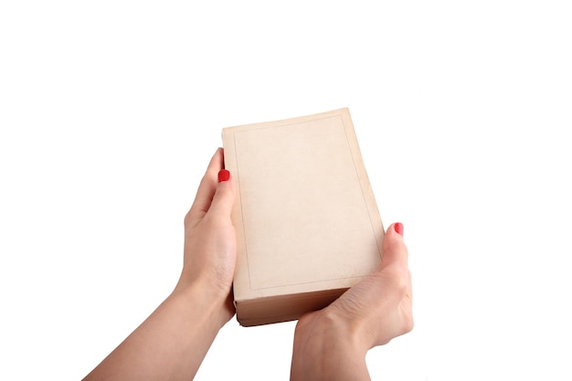 Hand holding vintage book isolated over white background