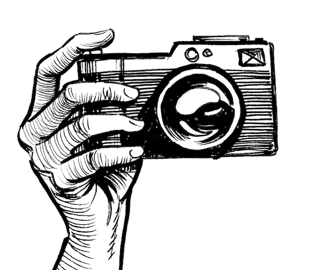 Hand holding a vintage camera. Ink black and white drawing