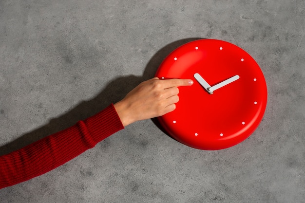 Hand holding wall clock still life