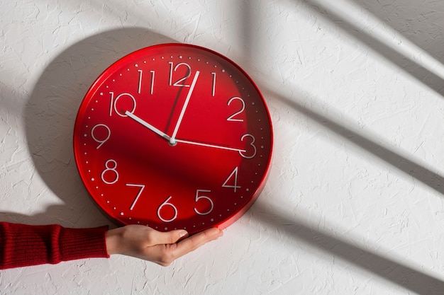 Hand holding wall clock still life