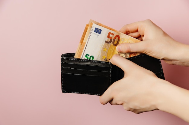 hand holding wallet with money