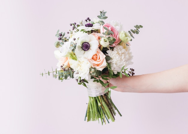 Hand holding wedding bouquet