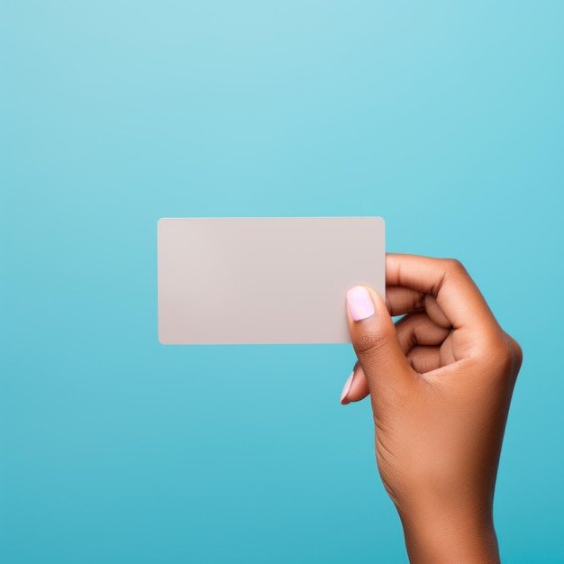 Hand Holding White Business Card Against Blue Background