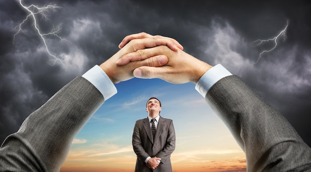 Hand holding window with man over sky