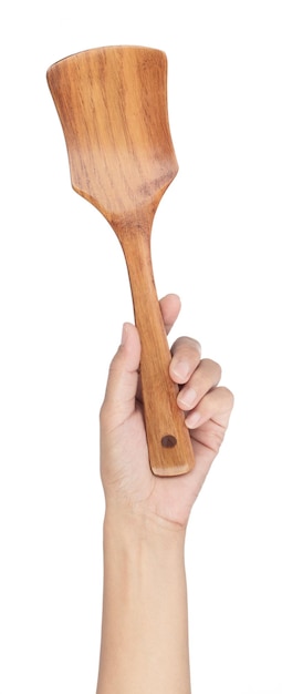 Hand holding wood spatula turner isolated on white background.