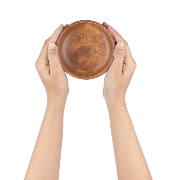 Hand holding Wooden bowl isolated on a white background