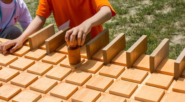 Hand holding wooden puzzle element in hand