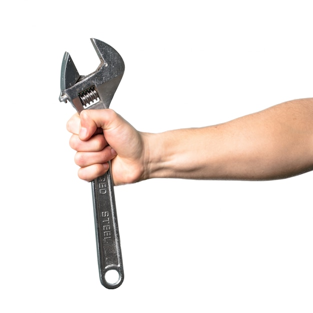 Photo hand holding wrench over isolated white background