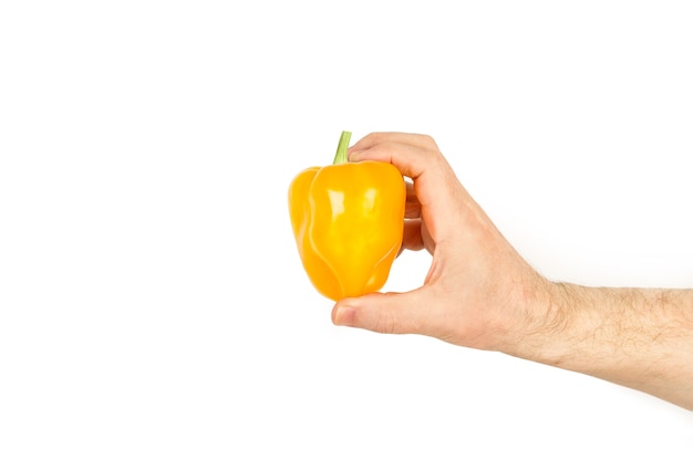 Hand holding a yellow bell pepper