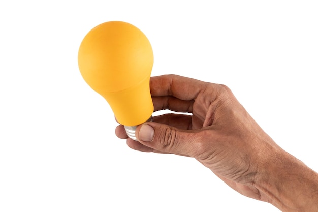 Hand holding yellow bulb on white background