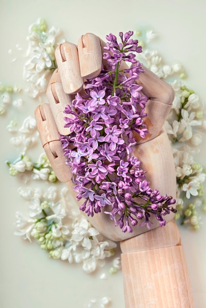 hand holds blooming lilacs in a milk bath
