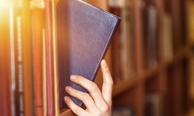 Hand holds book law book legal system library law library research