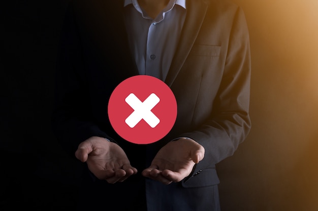 Hand holds icon,cancellation symbol,cancel icon.cross mark flat\
red icon.round x mark.cancel button.wrong.cross mark\
rejection.declined.on dark background.banner.copy space.place for\
text.