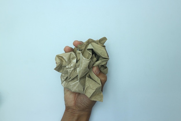 Photo the hand holds a lump of white paper. isolated on white background.