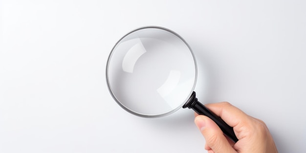 Photo a hand holds a magnifying glass against a white background illustrating the concept of investigation and scrutiny