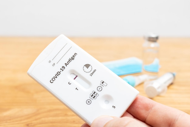 Hand holds rapid antigen test kit for viral disease COVID19 with negative result copy space