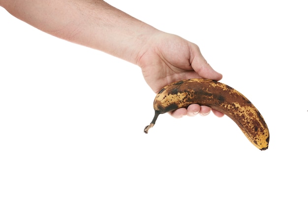 Hand holds a ripe banana on a white background template for designers