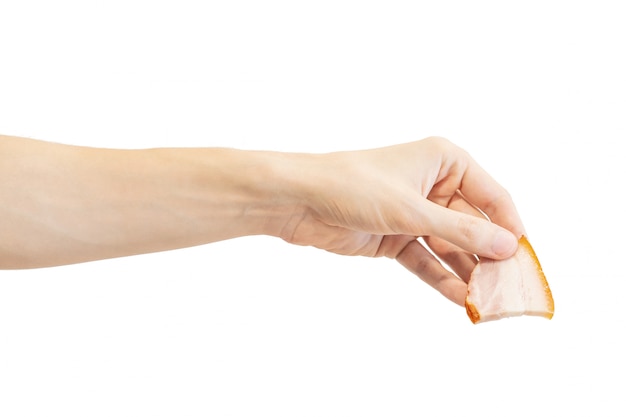 Photo hand holds a slice of smoked bacon isolated on white