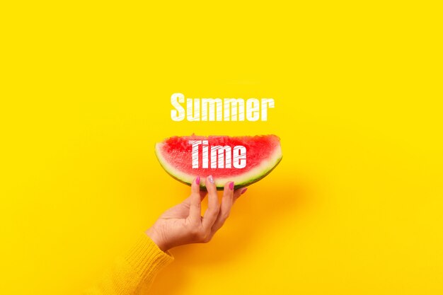 Hand holds watermelon slice.  Summertime concept.