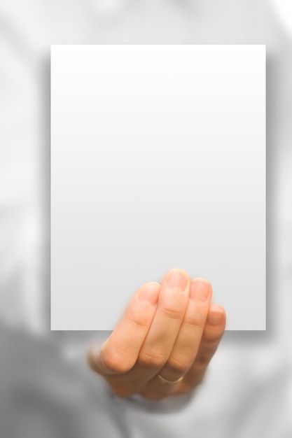 Photo hand holds white blank business card in focus