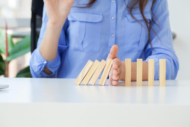 Hand holds wooden blocks the concept of stopping the crisis