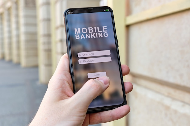 Hand houdt smartphone met mobiel bankieren en login en wachtwoord autorisatie-interface