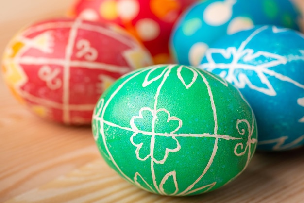 Hand inked pysanky (traditional decorated easter eggs in Ukraine) on wooden table. Celebrating Easter