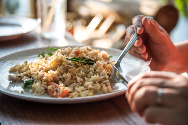 手は米の揚げた朝食を食べている