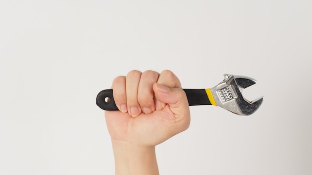 Photo the hand is holding an adjustable wrench isolatedxdxaon white background forehand picture