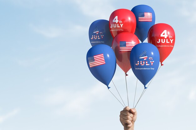 Photo a hand is holding balloons, celebrating forth of july