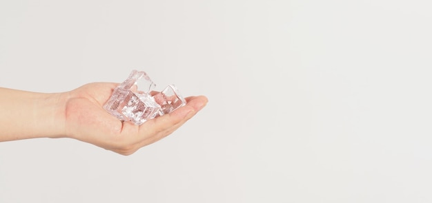 Hand is holding ice cubes on white backgroundx9