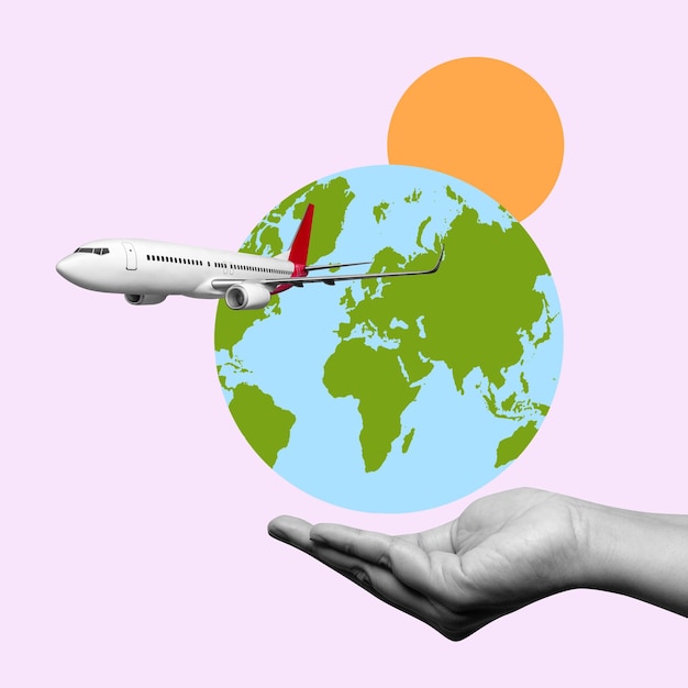 A hand is holding a white airplane in front of a globe
