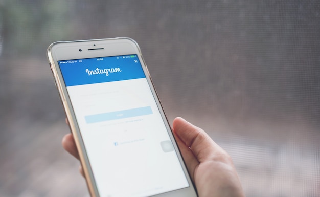 Photo hand is pressing the login screen instagram icon