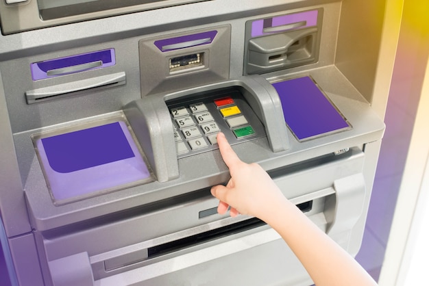 Photo hand of a kid using an atm