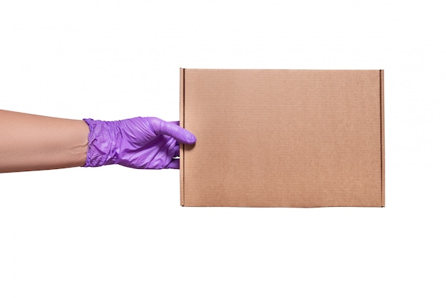 Hand in latex gloves holding cardboard box