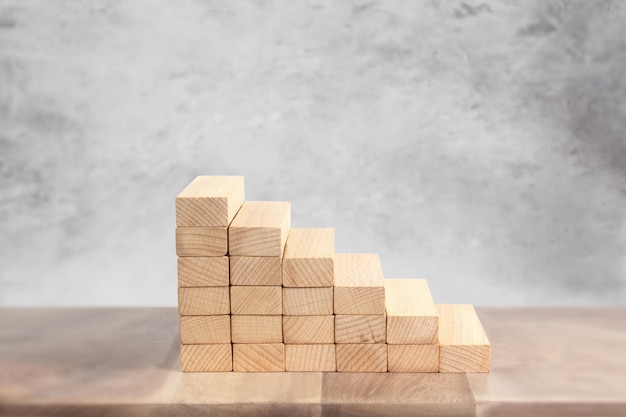 Hand liken person stepping up  toy staircase wood