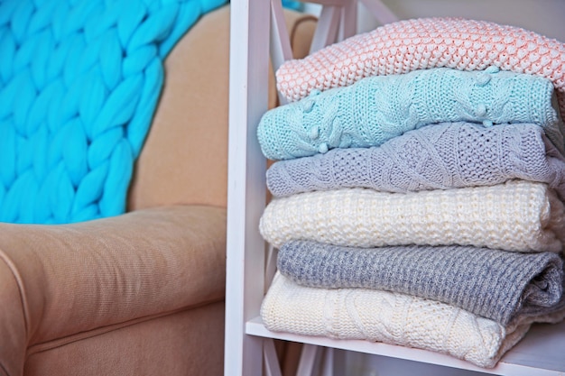 Hand made clothes on a shelf in a room