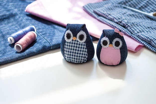 Hand made owls with materials on the table