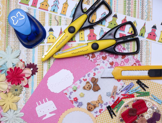 Hand made scrapbooking post card and tools lying on a table