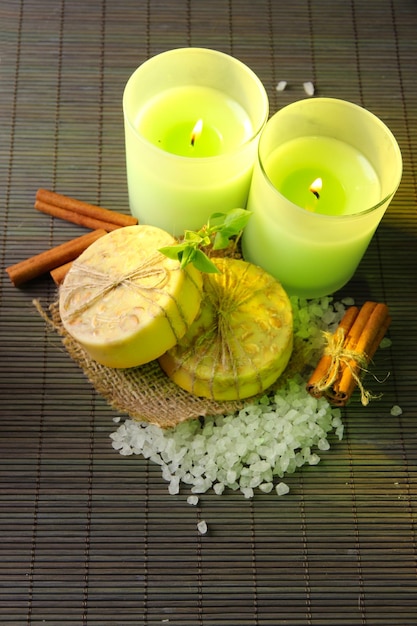 Hand made soap and candles on bamboo mat background